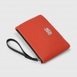 SUZY, grained leather zipper pouch in red hibiscus color with black wrist strap - side view