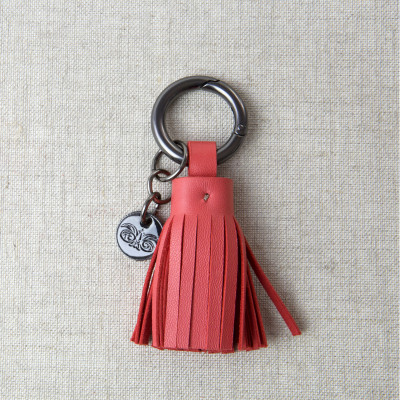 Key holder and bag charms TASSEL in lambskin hibiscus color and shiny gun finishing - front view - linen background