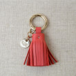 Key holder and bag charms TASSEL in lambskin, hibiscus color and gold - front view on linen background