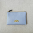 JULIE, zipper pouch in grained calfskin, lavender-grey color - front view on linen
