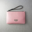 SUZY, grained leather zipper pouch in pink marshmallows color with black wrist strap - on linen