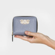 Compact zippered wallet in grained calf leather "MANON", French Blue color - in hand