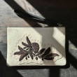 Grained leather zipper pouch "SUZY BLACK FLOWER" - off white and black - on black