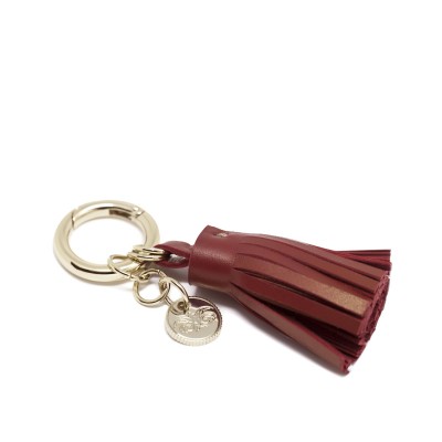 Porte-clés et bijoux de sac POMPON en agneau coloris bordeaux et or clair - vue à plat