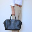 48h handbag for men in grained calf leather black color - on man