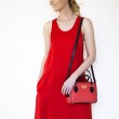 JULIETTE, leather handbag in grained leather, hibiscus color - on a model with a red dress