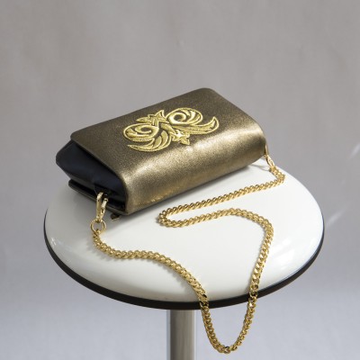 "AVA Baby" handbag in lambskin "taffeta" finished - antique gold and golden cannetille embroidery - on chair